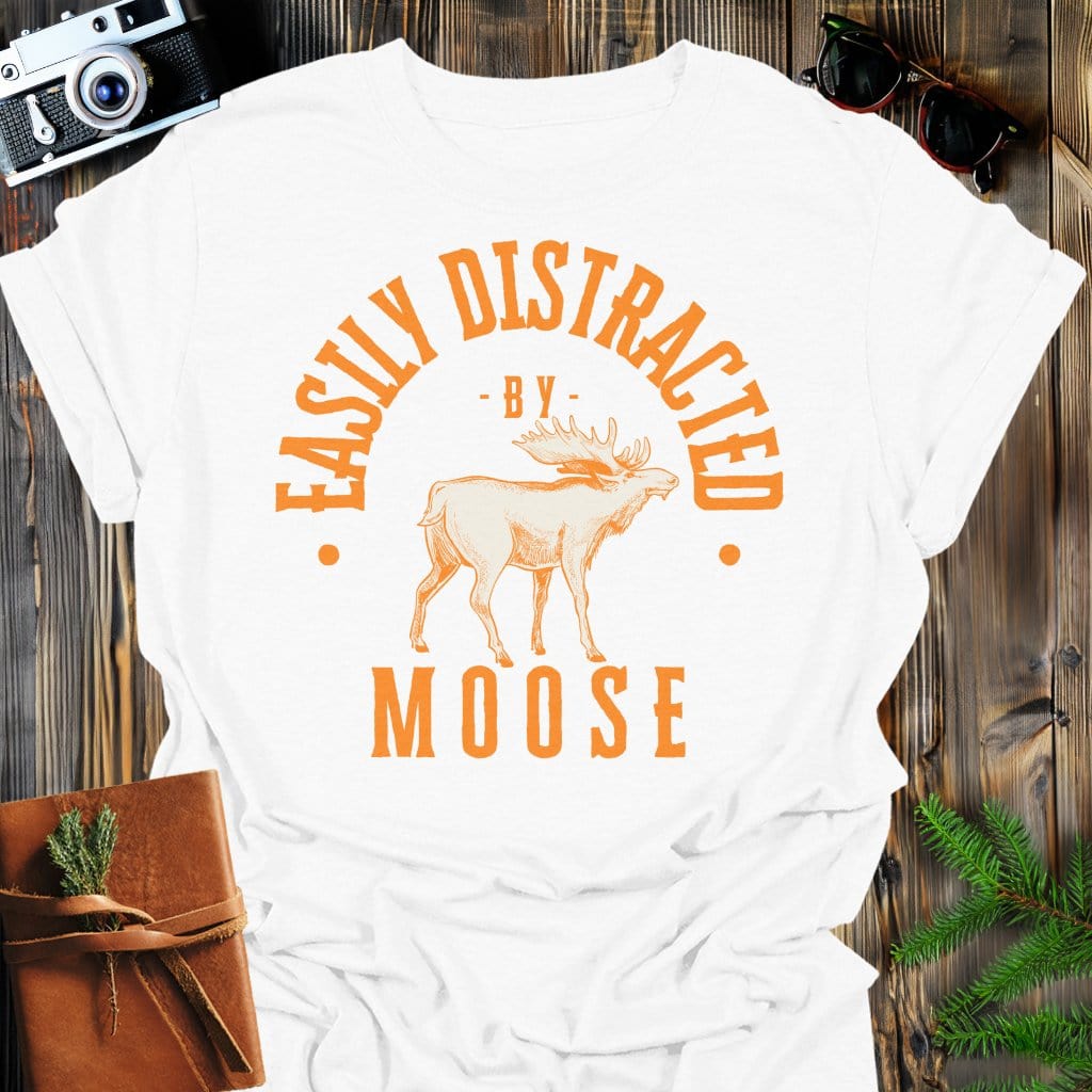 Distracted by Moose T-Shirt In S / White Lightweight adventure tee for outdoor lovers Perfect for hiking camping or road trips Made from soft breathable cotton for all-day comfort Ideal for nature lovers and adventurers FAYO Threads outdoor apparel remember Fun Awaits You Outside
