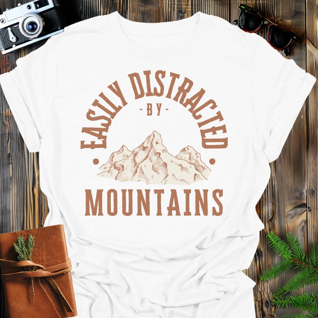 Distracted by Mountains T-Shirt In S / White Lightweight adventure tee for outdoor lovers Perfect for hiking camping or road trips Made from soft breathable cotton for all-day comfort Ideal for nature lovers and adventurers FAYO Threads outdoor apparel remember Fun Awaits You Outside