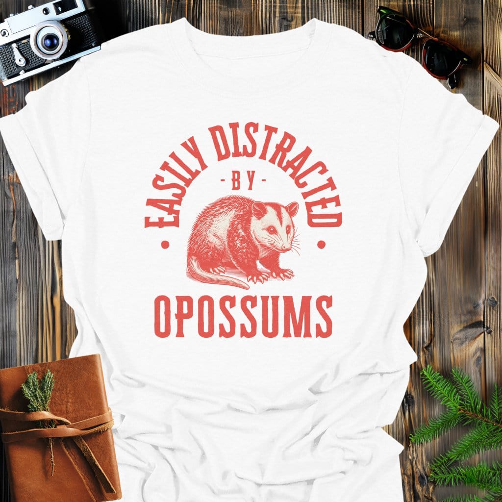Distracted by Opossums T-Shirt In S / White Lightweight adventure tee for outdoor lovers Perfect for hiking camping or road trips Made from soft breathable cotton for all-day comfort Ideal for nature lovers and adventurers FAYO Threads outdoor apparel remember Fun Awaits You Outside