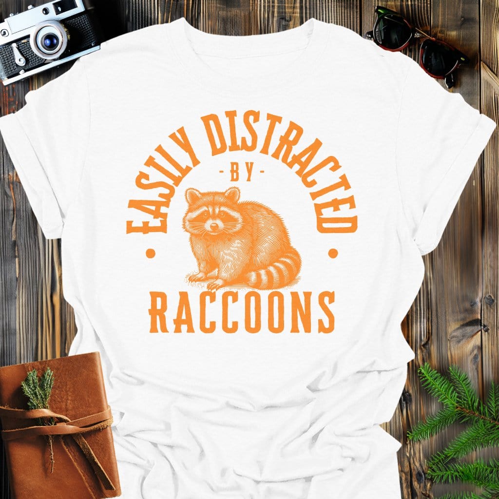 Distracted by Raccoons T-Shirt In S / White Lightweight adventure tee for outdoor lovers Perfect for hiking camping or road trips Made from soft breathable cotton for all-day comfort Ideal for nature lovers and adventurers FAYO Threads outdoor apparel remember Fun Awaits You Outside
