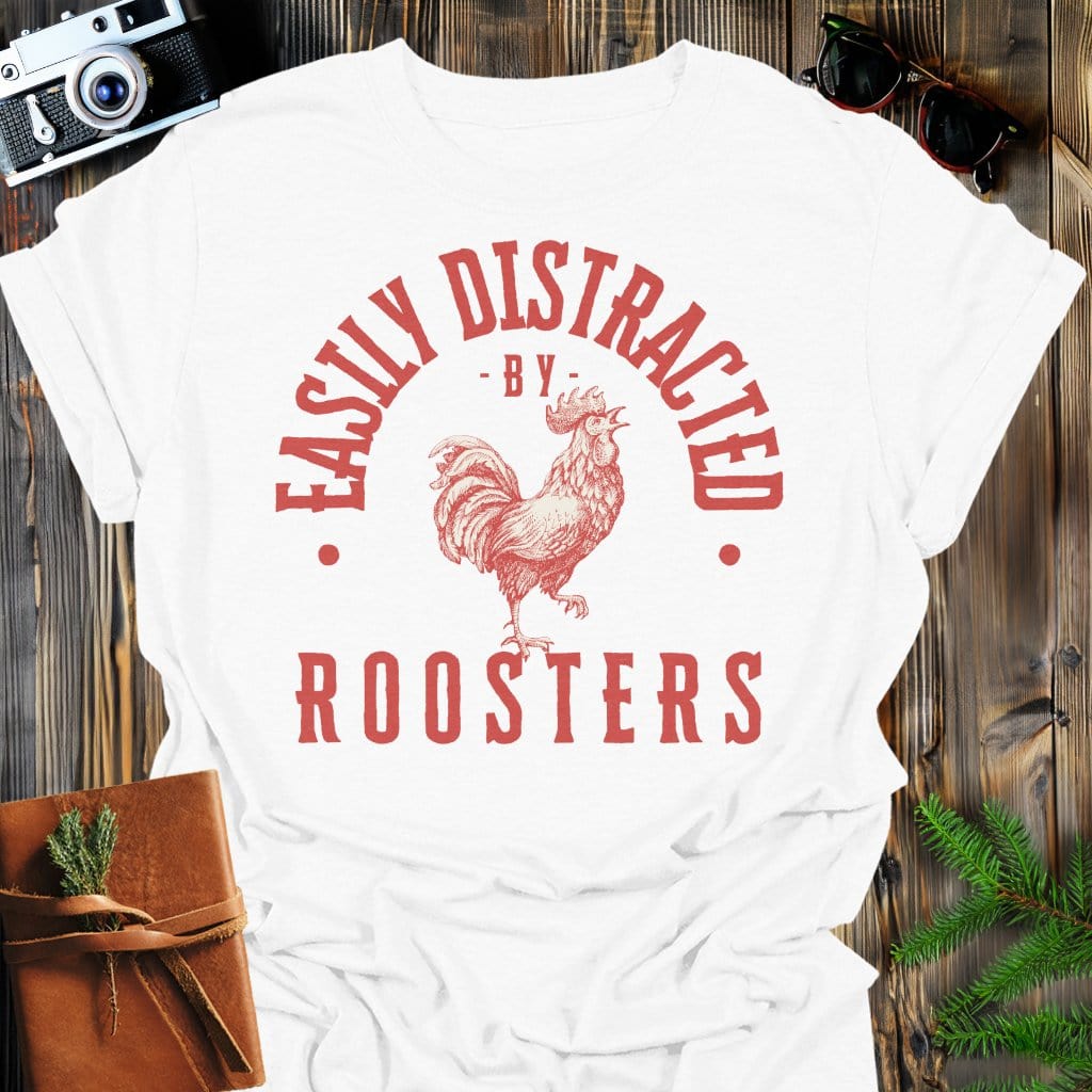 Distracted by Roosters T-Shirt In S / White Lightweight adventure tee for outdoor lovers Perfect for hiking camping or road trips Made from soft breathable cotton for all-day comfort Ideal for nature lovers and adventurers FAYO Threads outdoor apparel remember Fun Awaits You Outside