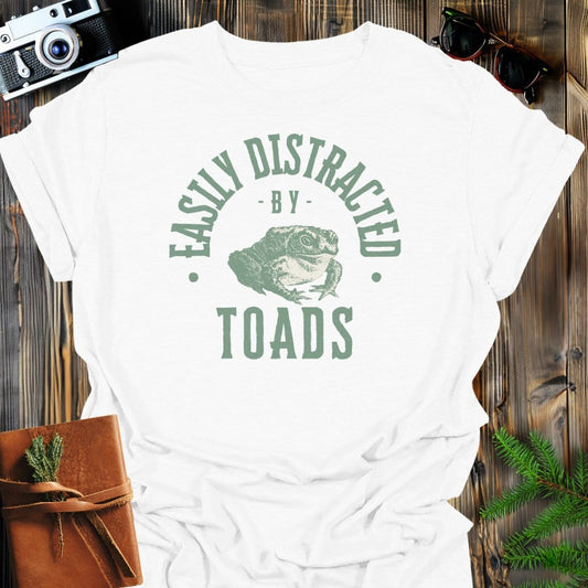 Distracted By Toads T-Shirt In S / White Lightweight adventure tee for outdoor lovers Perfect for hiking camping or road trips Made from soft breathable cotton for all-day comfort Ideal for nature lovers and adventurers FAYO Threads outdoor apparel remember Fun Awaits You Outside