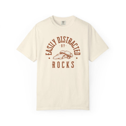 Easily Distracted by Rocks T-Shirt In Ivory / S Lightweight adventure tee for outdoor lovers Perfect for hiking camping or road trips Made from soft breathable cotton for all-day comfort Ideal for nature lovers and adventurers FAYO Threads outdoor apparel remember Fun Awaits You Outside