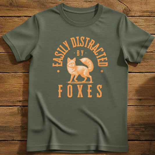 Distracted By Foxes T-Shirt In Military Green / S Lightweight adventure tee for outdoor lovers Perfect for hiking camping or road trips Made from soft breathable cotton for all-day comfort Ideal for nature lovers and adventurers FAYO Threads outdoor apparel remember Fun Awaits You Outside