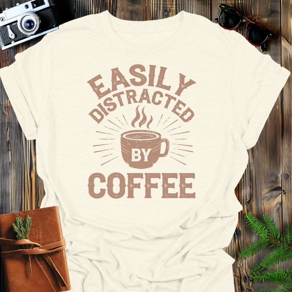Distracted by Coffee T-Shirt In Natural / S Lightweight adventure tee for outdoor lovers Perfect for hiking camping or road trips Made from soft breathable cotton for all-day comfort Ideal for nature lovers and adventurers FAYO Threads outdoor apparel remember Fun Awaits You Outside