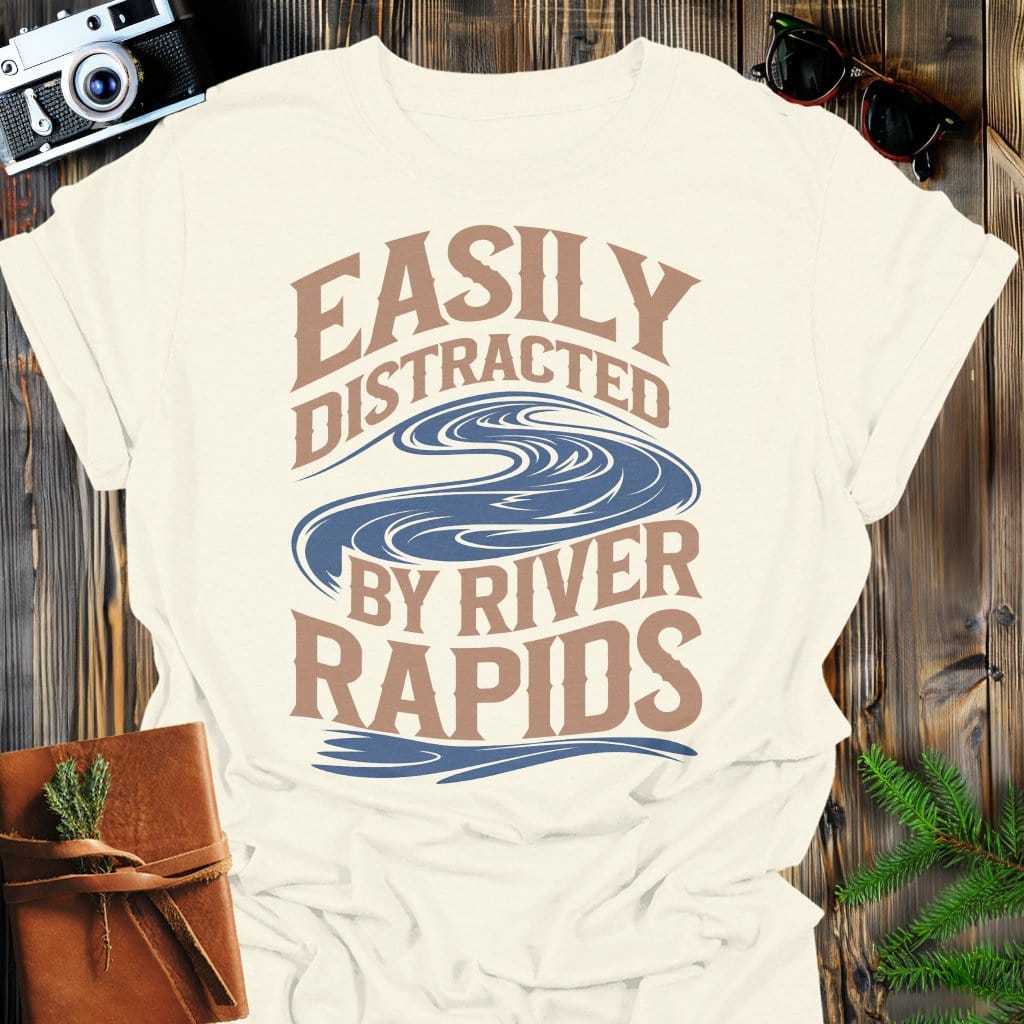 Distracted by Rapids T-Shirt In Natural / S Lightweight adventure tee for outdoor lovers Perfect for hiking camping or road trips Made from soft breathable cotton for all-day comfort Ideal for nature lovers and adventurers FAYO Threads outdoor apparel remember Fun Awaits You Outside