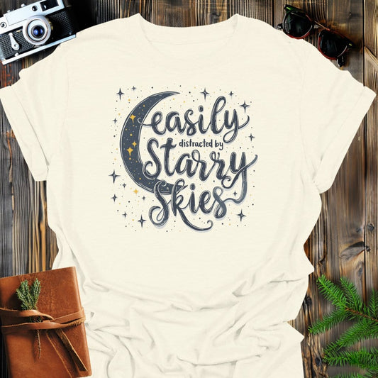Distracted by Starry Nights T-Shirt In Natural / S Lightweight adventure tee for outdoor lovers Perfect for hiking camping or road trips Made from soft breathable cotton for all-day comfort Ideal for nature lovers and adventurers FAYO Threads outdoor apparel remember Fun Awaits You Outside