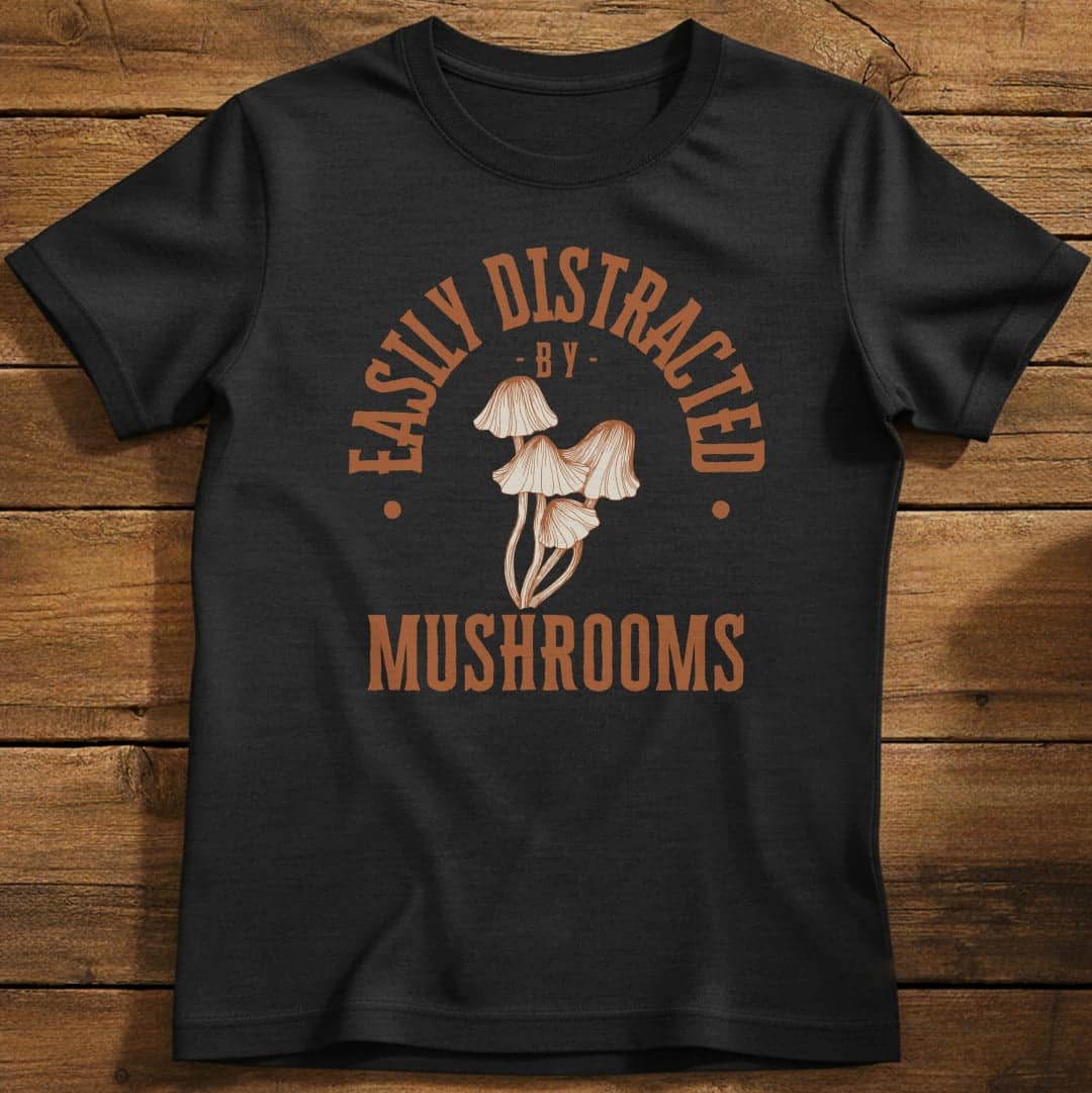 Distracted by Mushrooms T-Shirt In S / Black Lightweight adventure tee for outdoor lovers Perfect for hiking camping or road trips Made from soft breathable cotton for all-day comfort Ideal for nature lovers and adventurers FAYO Threads outdoor apparel remember Fun Awaits You Outside