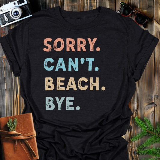 Sorry Can't Beach Bye T-Shirt In Black / S Lightweight adventure tee for outdoor lovers Perfect for hiking camping or road trips Made from soft breathable cotton for all-day comfort Ideal for nature lovers and adventurers FAYO Threads outdoor apparel remember Fun Awaits You Outside