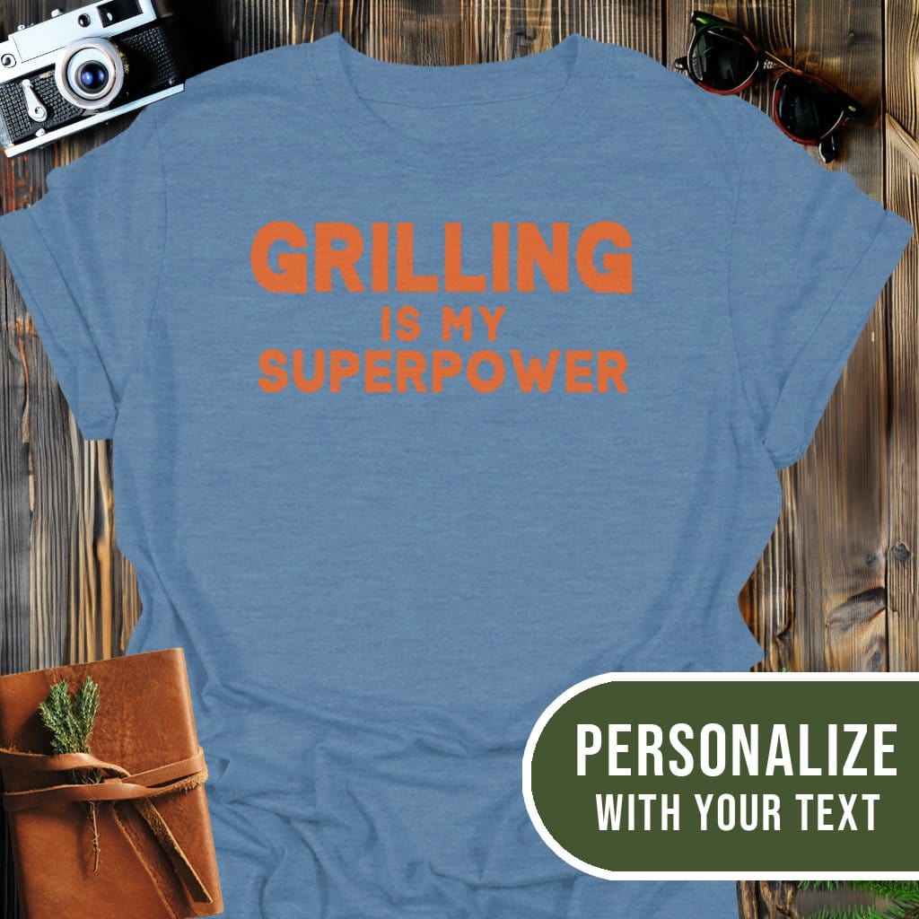 Personalized Grilling Superpower T-Shirt In Heather Indigo / S Lightweight adventure tee for outdoor lovers Perfect for hiking camping or road trips Made from soft breathable cotton for all-day comfort Ideal for nature lovers and adventurers FAYO Threads outdoor apparel remember Fun Awaits You Outside