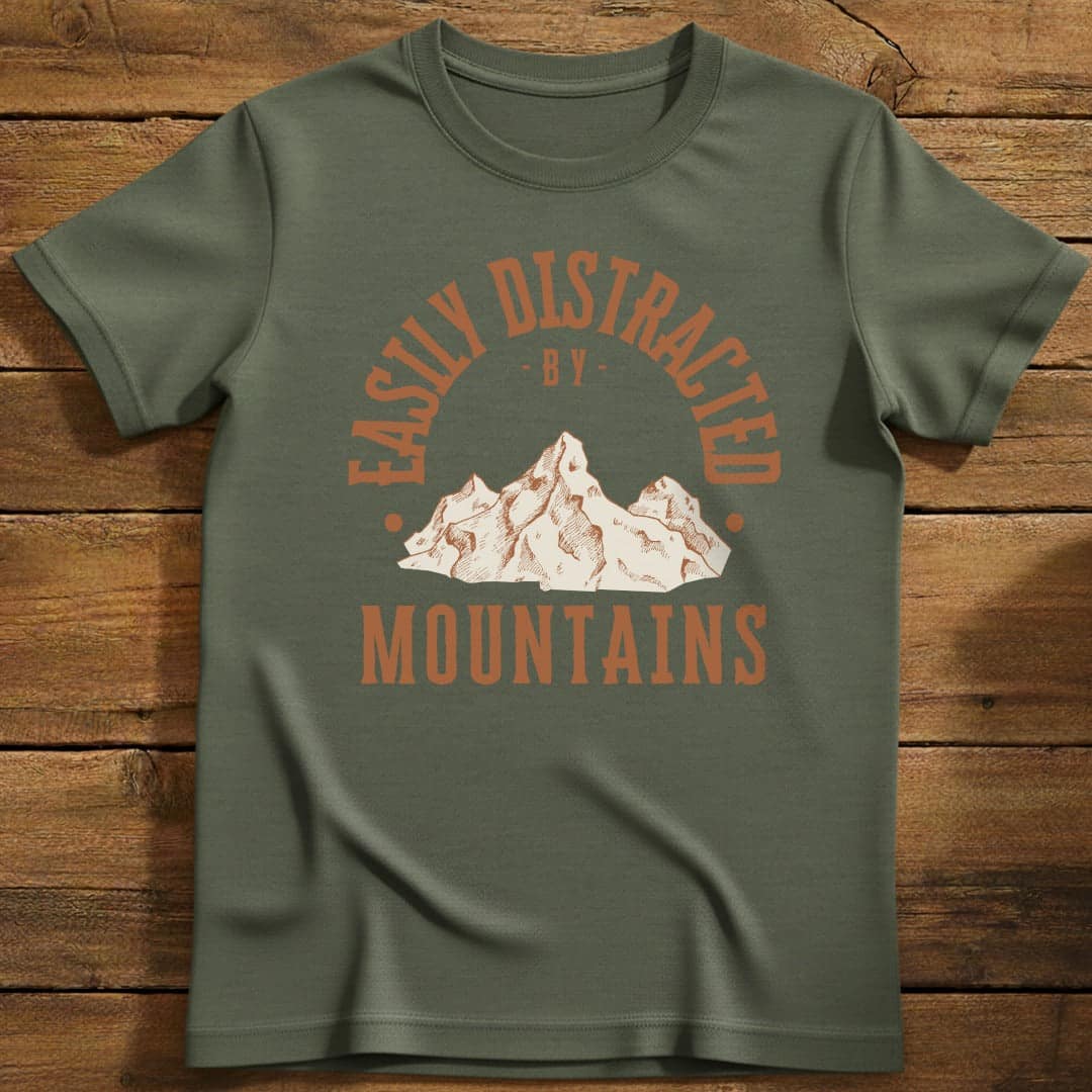 Distracted by Mountains T-Shirt In S / Military Green Lightweight adventure tee for outdoor lovers Perfect for hiking camping or road trips Made from soft breathable cotton for all-day comfort Ideal for nature lovers and adventurers FAYO Threads outdoor apparel remember Fun Awaits You Outside