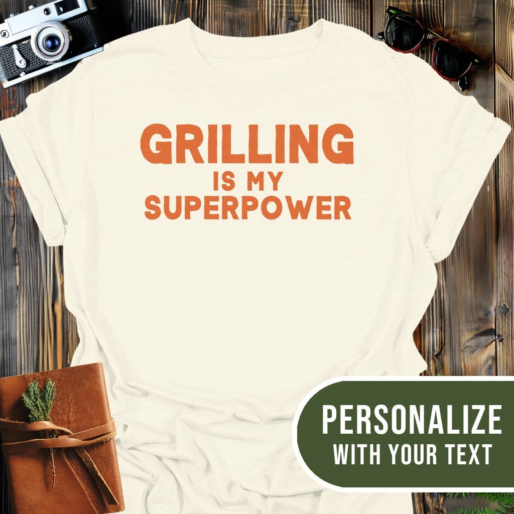 Personalized Grilling Superpower T-Shirt In Natural / S Lightweight adventure tee for outdoor lovers Perfect for hiking camping or road trips Made from soft breathable cotton for all-day comfort Ideal for nature lovers and adventurers FAYO Threads outdoor apparel remember Fun Awaits You Outside