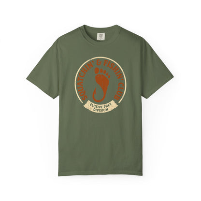 Squatchin' & Fishin' Club T-Shirt In Sage / S Lightweight adventure tee for outdoor lovers Perfect for hiking camping or road trips Made from soft breathable cotton for all-day comfort Ideal for nature lovers and adventurers FAYO Threads outdoor apparel remember Fun Awaits You Outside